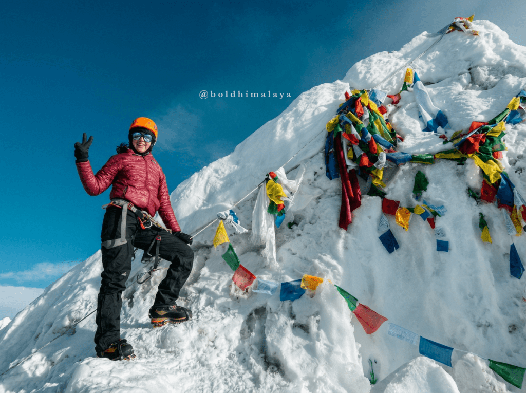 Female climber ascending a snowy ridge on Island Peak Climbing