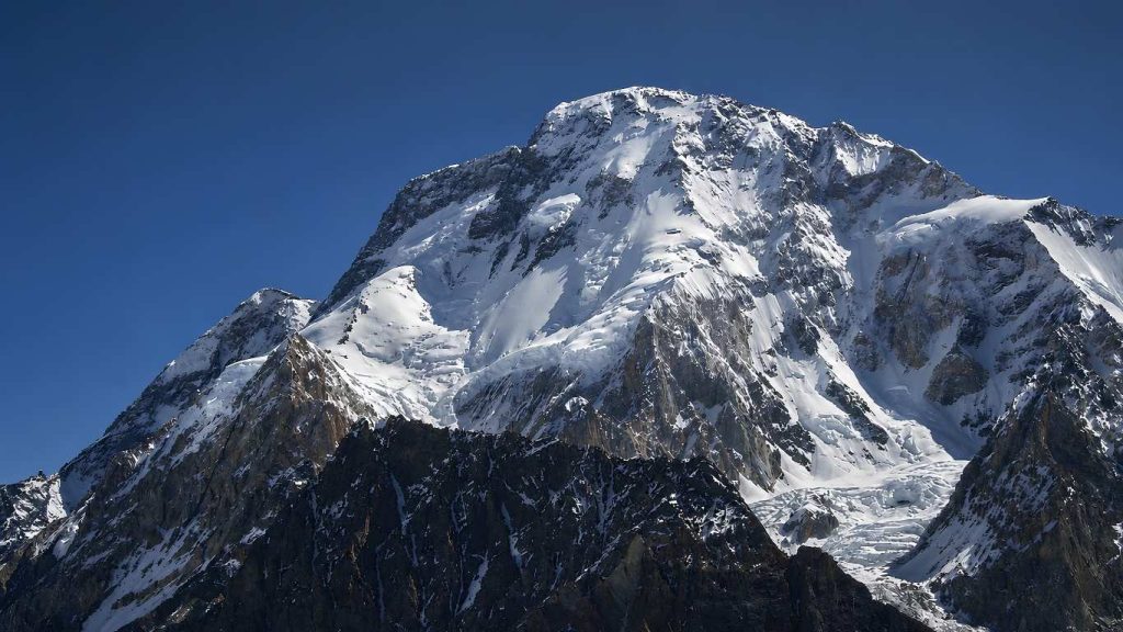 Mount Broad Peak (8,051m) in the Karakoram range near K2, covered in snow under a clear sky.
