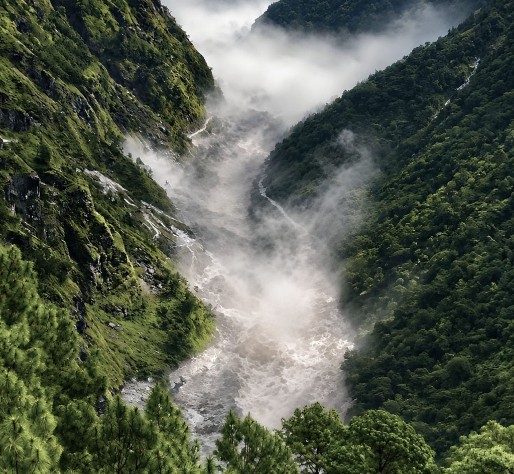 Powerful Rasuwa flash flood flowing through a steep mountain valley in Nepal.