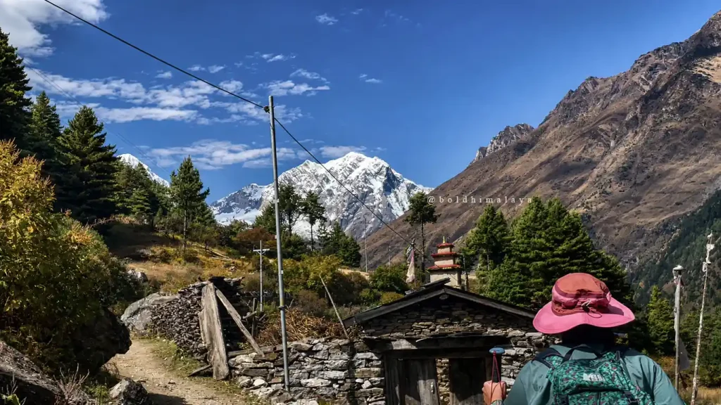 Manaslu Circuit Trek in September with a trekker walking through a mountain village