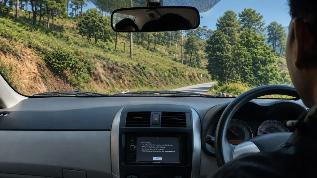 A private jeep is driving on a mountain road.